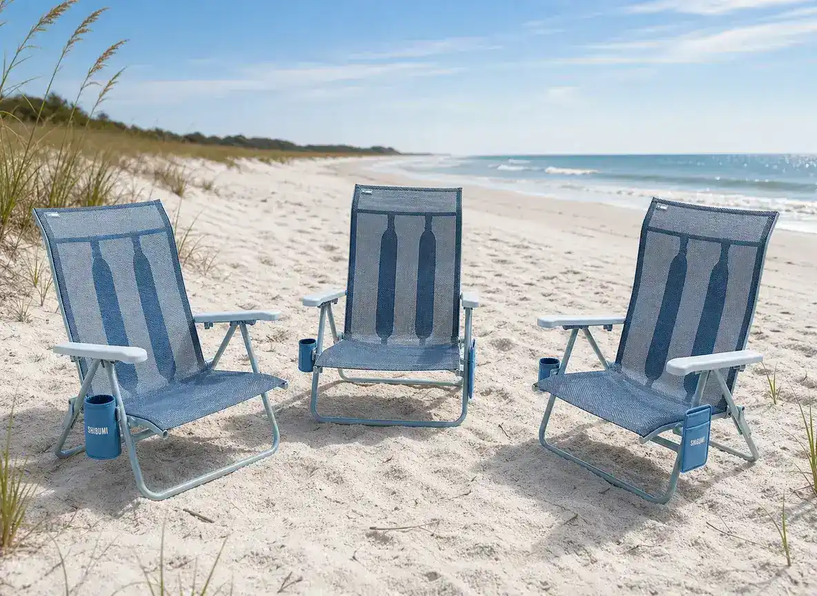 Three Shibumi Sky beach chairs on a South Carolina beach with sea oats and dunes