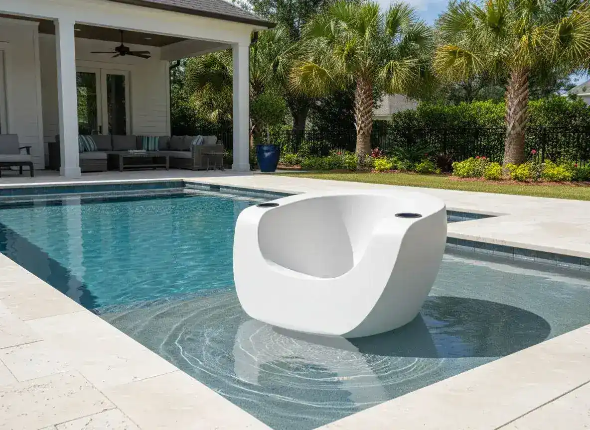 White Tenjam Moon Chair on a Hilton Head Island pool tanning ledge with palmetto palms and covered patio